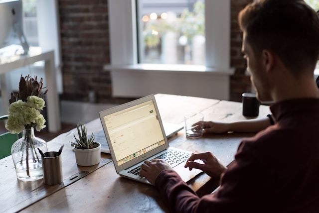 man typing on computer