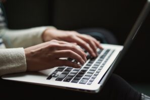 man typing on computer