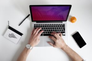 man typing on computer