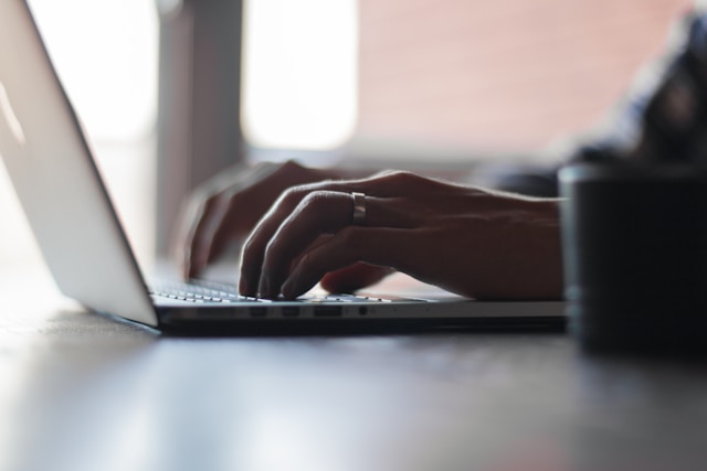 man typing on computer